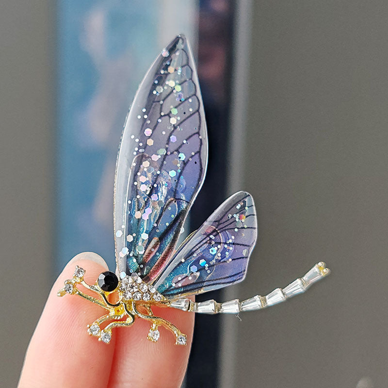 Charming acrylic dragonfly brooch pin on white background