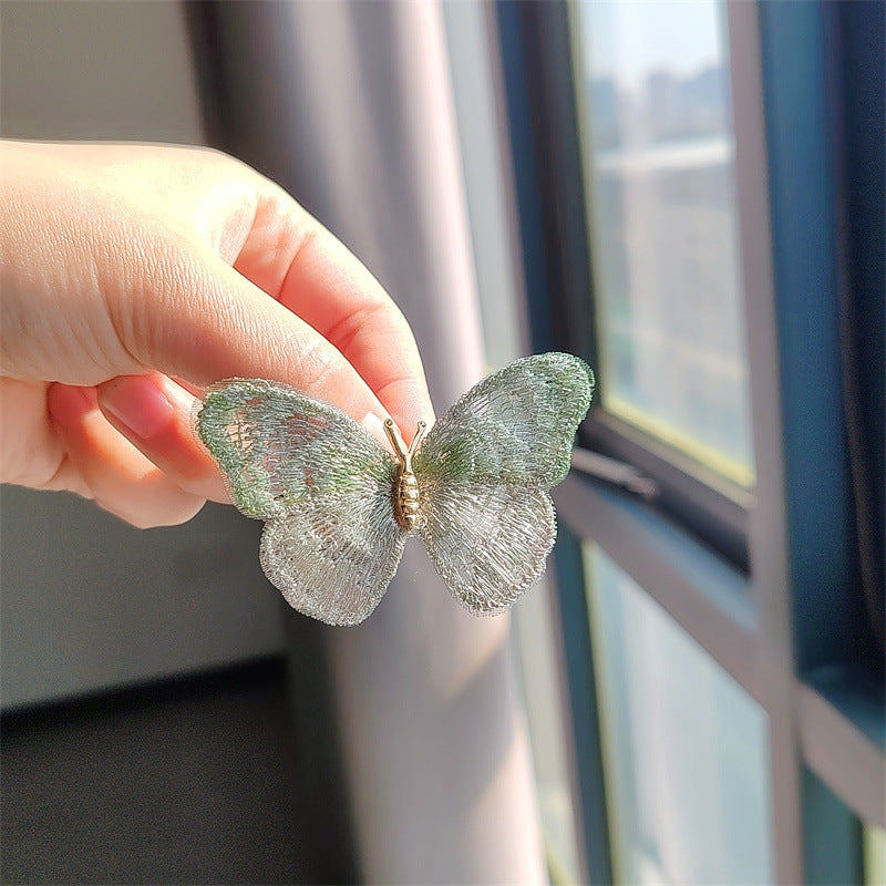 Butterfly embroidered brooch in purple