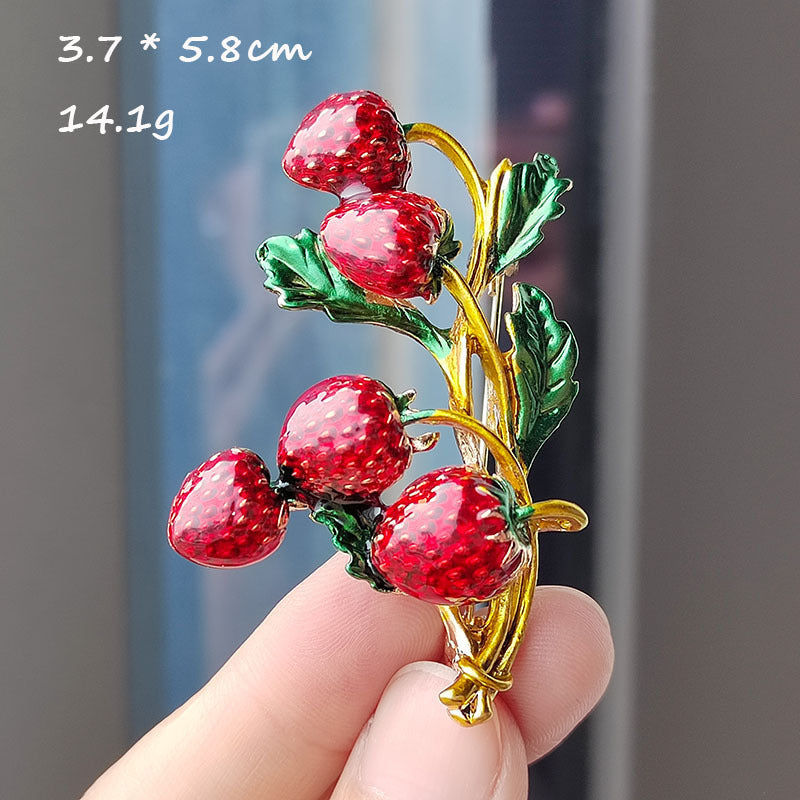Unique strawberry design brooch on fabric