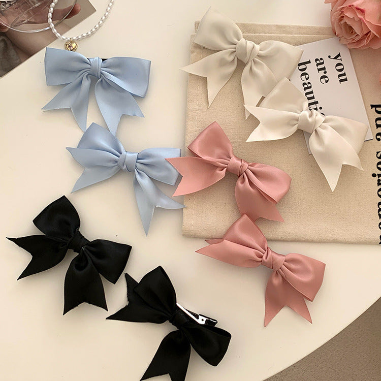 Blue bow hair clip styled on child's hair