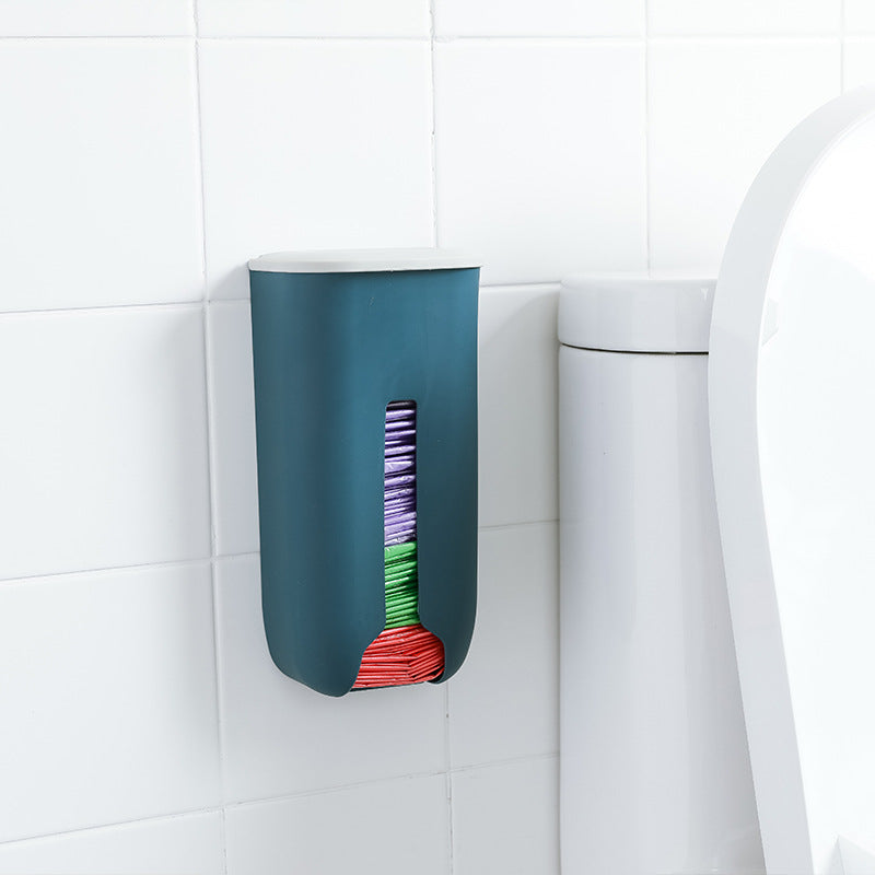 Wall-mounted trash bag organizer in kitchen