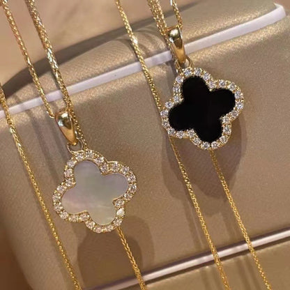Four-leaf clover necklace lying on a marble surface