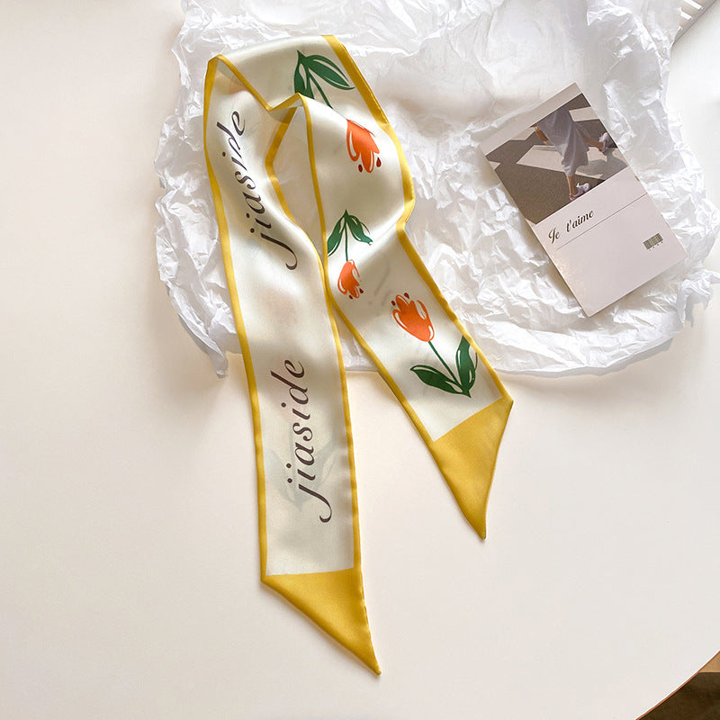 Yellow floral scarf tied to bag