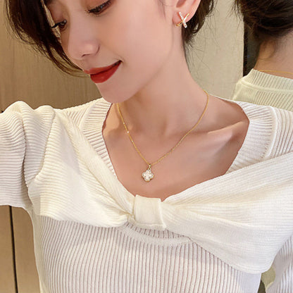 Stylish four-leaf clover necklace worn on a model