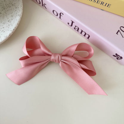 Blue bow hair clip styled on child's hair