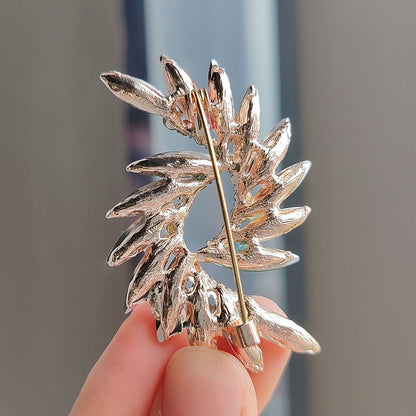 Floral crystal brooch pin on fabric background