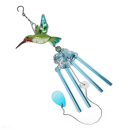 Decorative wind chime hanging in garden setting