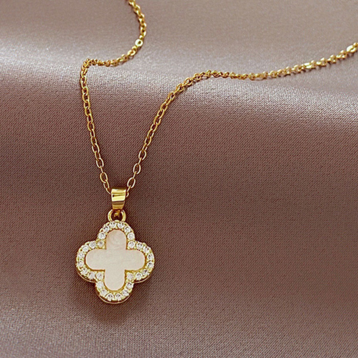 Stylish four-leaf clover necklace worn on a model