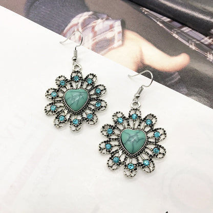 Close-up of turquoise earrings in vintage design - image 2