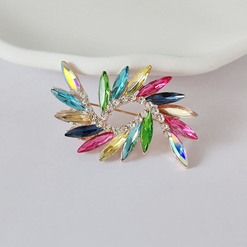 Floral crystal brooch pin on fabric background