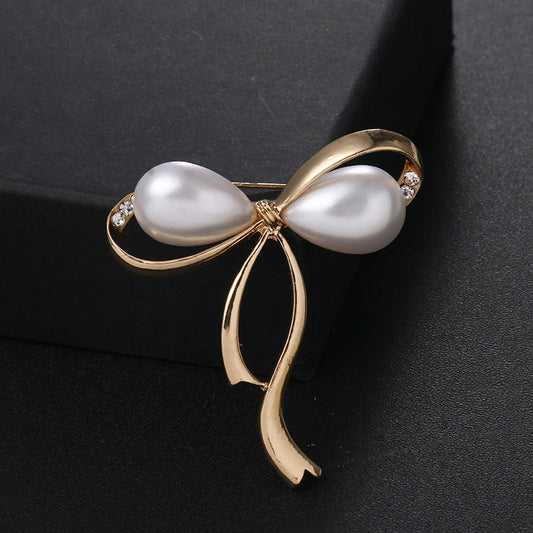 Elegant Pearl Bow Brooch with Rhinestones - Image 1